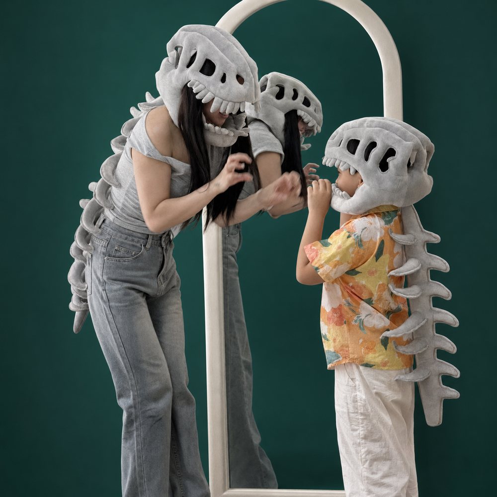 A parent and child wearing Little Roar plushes together