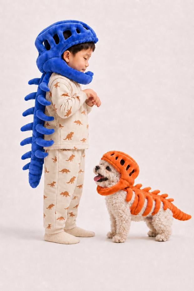 Mini Roar plush worn by a child beside a dog